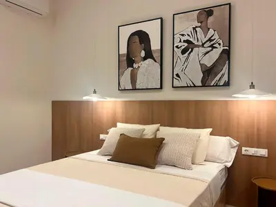 a bedroom with a bed with two pictures on the wall at Pivote Flats-Puerto B in Valencia