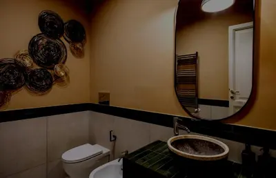 a bathroom with a sink and a mirror and a toilet at Apartamento Aleyda in Valencia