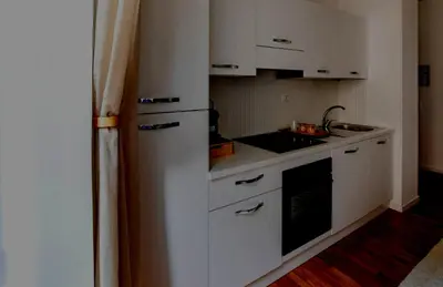 a kitchen with a white refrigerator and a sink at Apartamento Aleyda in Valencia