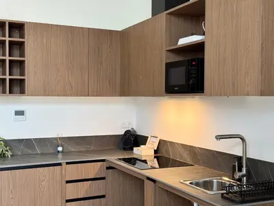 a kitchen with wooden cabinets and a sink at Boutique Room - Plaza Tower in Valencia
