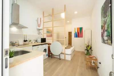 a kitchen with a sink and a chair in a room at Loft Centrico 2 pax Poyector TV in Valencia