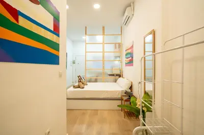 a bedroom with a bed and a painting on the wall at Loft Centrico 2 pax Poyector TV in Valencia
