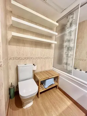 a bathroom with a toilet and a bath tub at Beachfront Family Appartment with Pool in Valencia