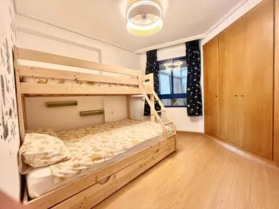 a bedroom with two bunk beds in it at Beachfront Family Appartment with Pool in Valencia