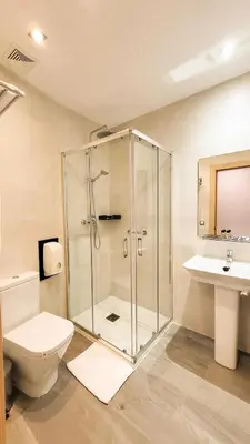 a bathroom with a shower and a toilet and a sink at El Puig in El Puig
