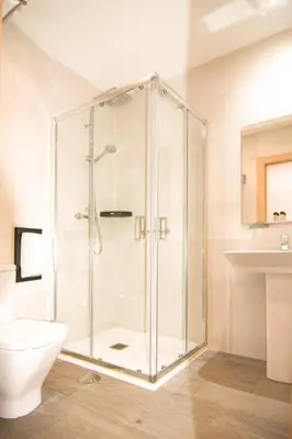 a bathroom with a shower with a toilet and a sink at El Puig in El Puig