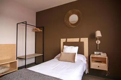 a bedroom with a bed and a mirror on the wall at El Puig in El Puig