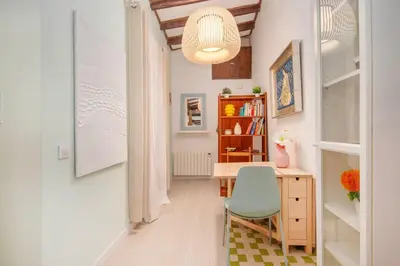 a home office with a desk and a blue chair at La Casa de las CestaS in Valencia