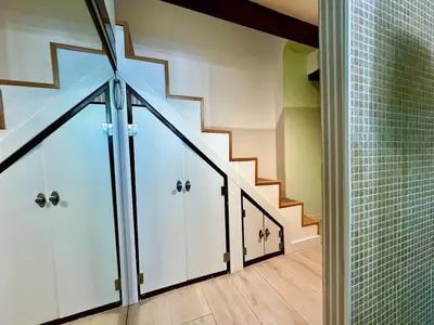 a hallway with white cabinets and a stair case at La Casa de las CestaS in Valencia