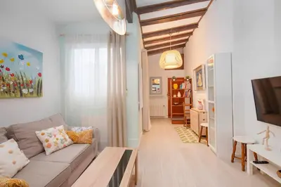 a living room with a couch and a table at La Casa de las CestaS in Valencia