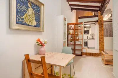 a dining room with a table and a painting on the wall at La Casa de las CestaS in Valencia
