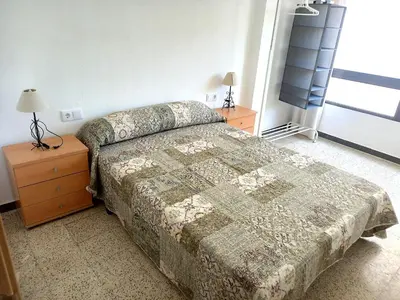 a bedroom with a bed and a dresser and a window at Estirpe, 4-7 in Cullera