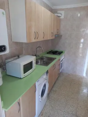 a small kitchen with a microwave and a sink at Estirpe, 4-7 in Cullera