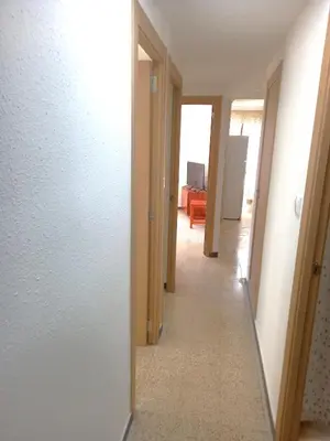 a hallway leading to a living room with a hallway at Estirpe, 4-7 in Cullera
