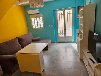 a living room with a couch and a table at Cosy house near the castle in Cullera