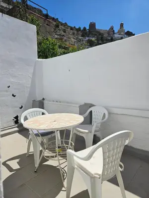 a table and two chairs and a table and chairs on a patio at Cosy house near the castle in Cullera