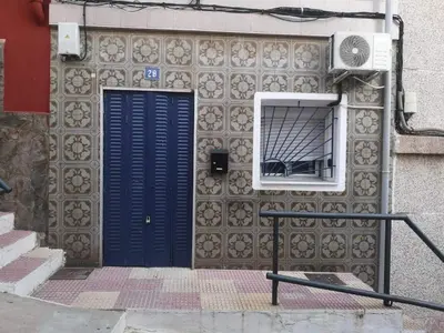a building with a blue door and a window at Cosy house near the castle in Cullera