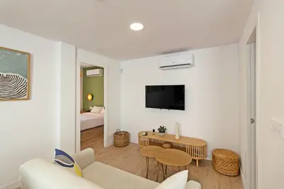 a living room with a couch and a table at GuestReady - Lovely family home in El Cabanyal in Valencia