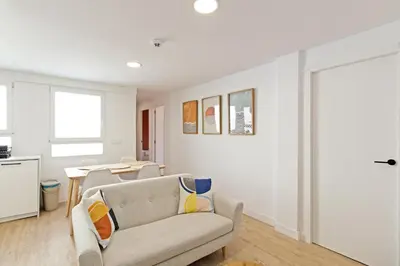 a living room with a couch and a table at GuestReady - Lovely family home in El Cabanyal in Valencia