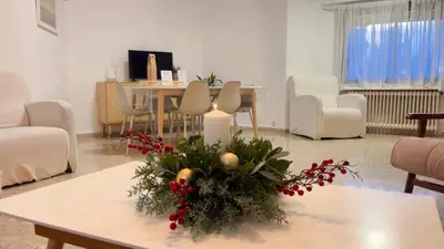 a living room with a table with a christmas arrangement on it at Villa Bobal in Requena