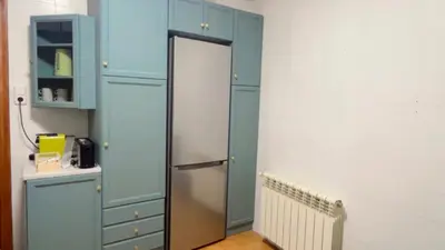 a room with blue cabinets and a refrigerator at Villa Bobal in Requena