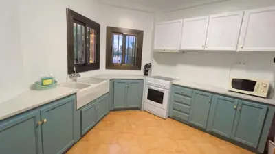 a kitchen with blue cabinets and white appliances at Villa Bobal in Requena