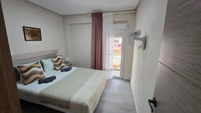 a bedroom with a bed with pillows and a window at Apartamento Musical in Cullera