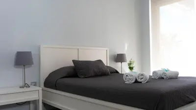 a bedroom with a bed with two towels on it at El Coso in Valencia