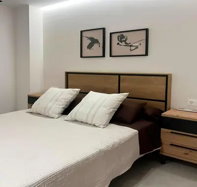 a bedroom with a white bed with two pillows at Apartamento Estilo in Valencia