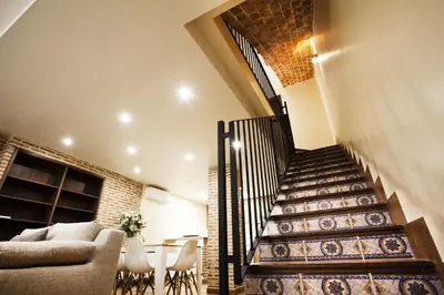 a staircase in a house with a couch and a table at El Rincon De Jara in Caudiel