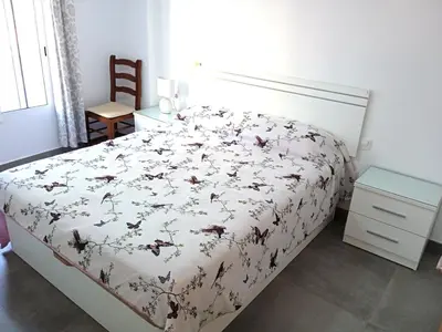 a bedroom with a bed with a bedspread with butterflies on it at Nautic, 4-I in Cullera