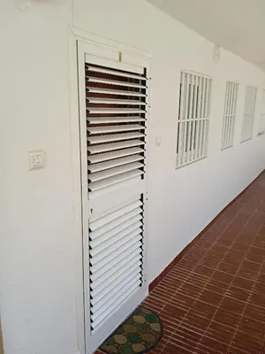 a white wall with a door in a room at Nautic, 4-I in Cullera