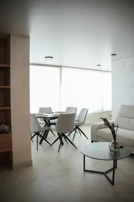 a living room with a couch and a table and chairs at Sucro Playa Apartment in Cullera