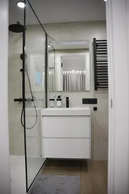 a bathroom with a white sink and a shower at Sucro Playa Apartment in Cullera
