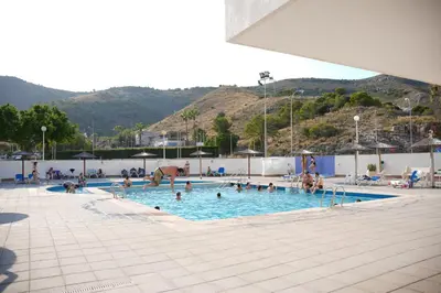 a large swimming pool with people in it at Sucro Playa Apartment in Cullera