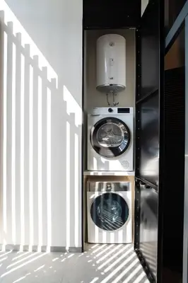 two washing machines sitting next to a white fence at Central loft 60 m2 ideal for small families in Valencia