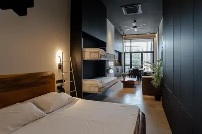 a bedroom with two bunk beds and a living room at Central loft 60 m2 ideal for small families in Valencia