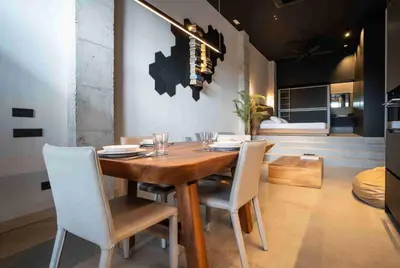 a dining room with a wooden table and white chairs at Loft céntrico, 60 m2 ideal para familias pequeñas in Valencia