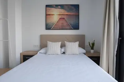 a bedroom with a white bed and a pier at Casa Blanca - Villa con piscina in Chiva
