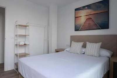 a bedroom with a white bed and a picture on the wall at Casa Blanca - Villa con piscina in Chiva