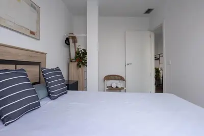 a bedroom with a bed with blue and white pillows at Casa Blanca - Villa con piscina in Chiva