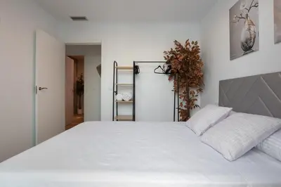 a bedroom with a large white bed with two pillows at Casa Blanca - Villa con piscina in Chiva