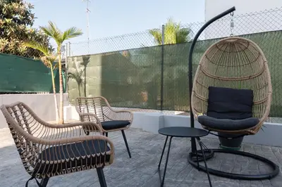 two chairs and a swing on a patio at Casa Blanca - Villa con piscina in Chiva