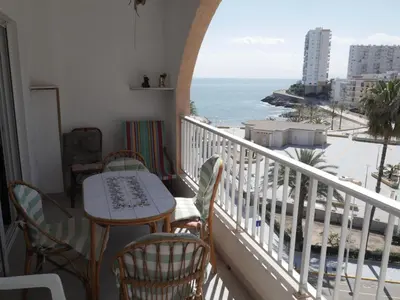 a balcony with a table and chairs and the ocean at Navarrete, 4-20 in Cullera