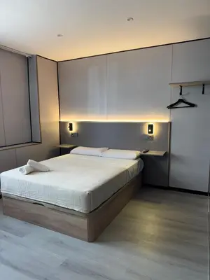 a bedroom with a large bed with white sheets at ITOUR Hotel & Coffee in Museros