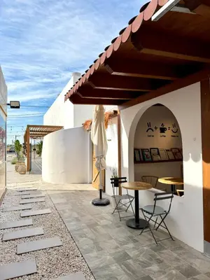 a wooden table and chairs under a wooden pergola at ITOUR Hotel & Coffee in Museros