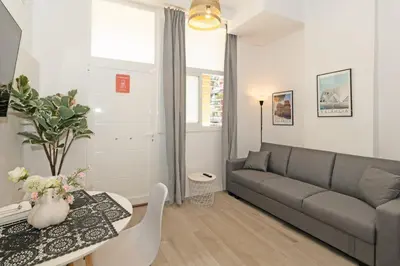 a living room with a couch and a table at GuestReady - Bright home in Valencia in Valencia
