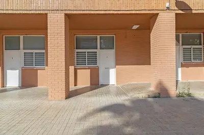 a brick building with two white doors on it at GuestReady - Bright home in Valencia in Valencia