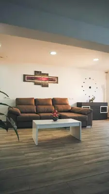 a living room with a couch and a coffee table at Villa Prestige Beach in Mareny Barraquetas