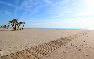 a wooden path on the beach with palm trees at Beautiful Apartment In Canet De Berenguer in Canet de Berenguer